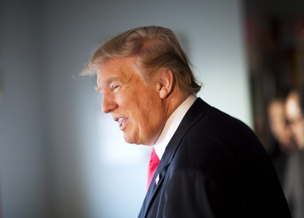 Republican presidential candidate Donald Trump talks with diners while visiting the Chez Vachon restaurant Sunday, Feb. 7, 2016, in Manchester, N.H. (AP Photo/David Goldman)